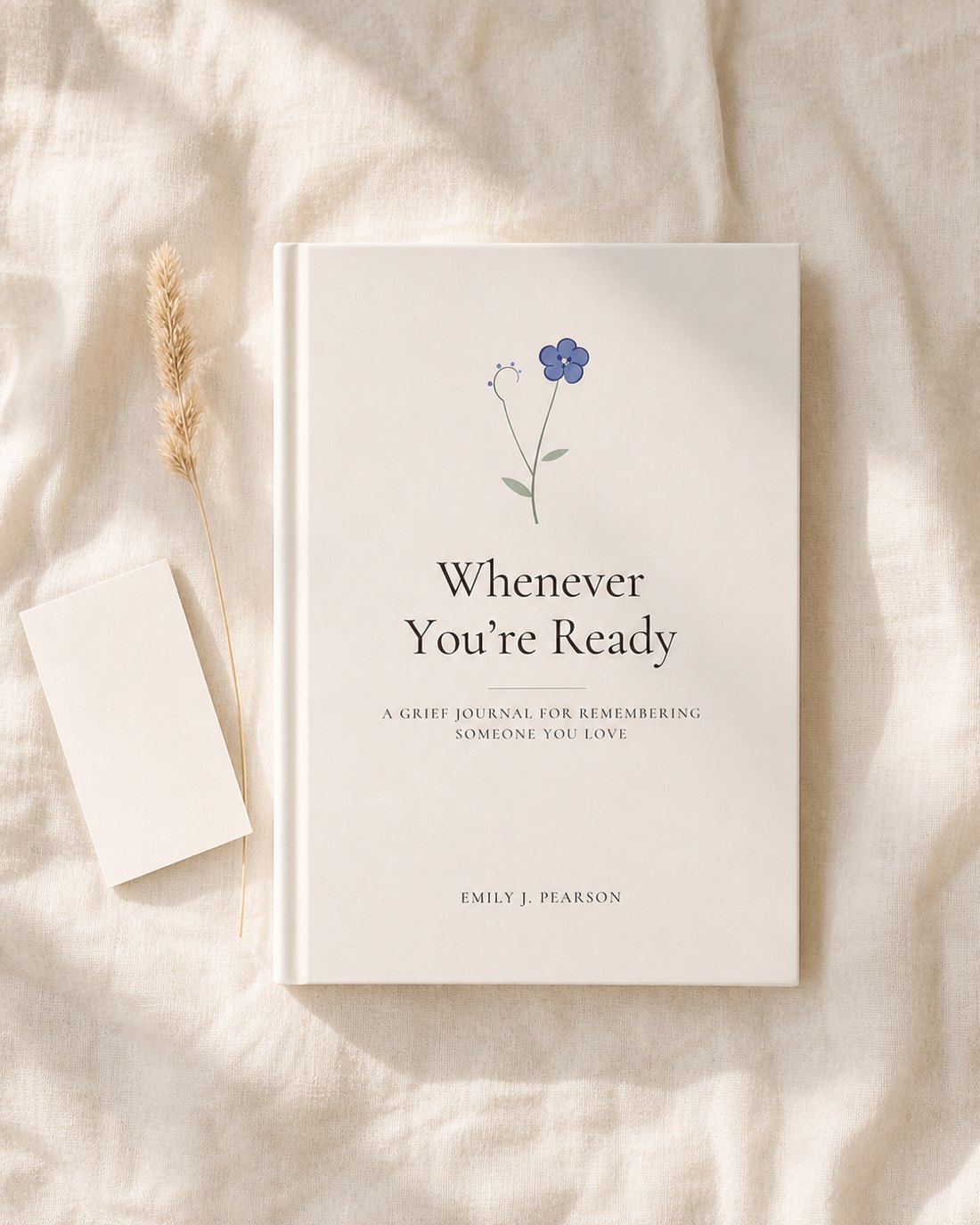 The journal on soft linen beside a blank notecard